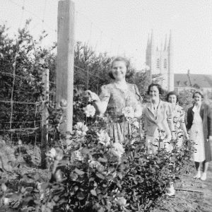 Four women in garden with St Johns College in background 