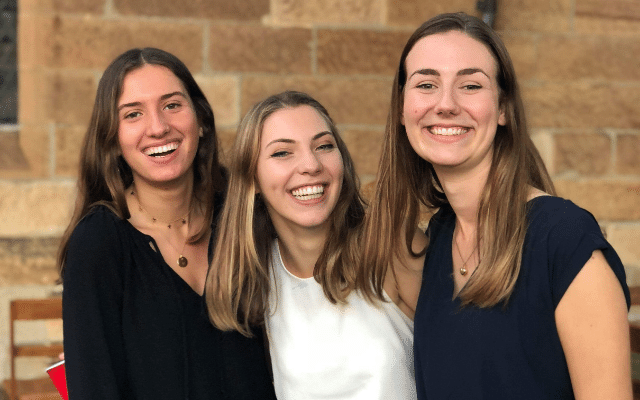 Sancta students having fun at a social event, standing next to each other